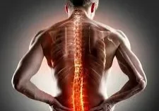 A man with his back turned and the spinal cord in pain.